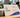 A high-resolution photograph of a stack of premium eco-friendly business cards with visible recycled texture.