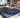 A premium, high-quality school prospectus with a soft-touch finish resting on a modern wooden desk, surrounded by natural lig